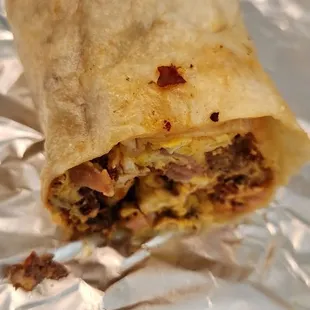 This is a mixed breakfast burrito . it has ham, bacon and chorizo, and egg.. If I remember right. Cash cost...$14.05 December 2023.