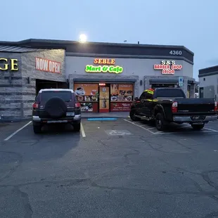 two trucks parked in front of the store