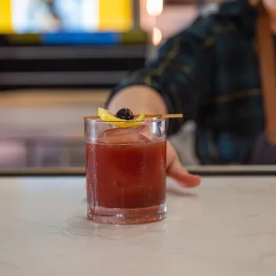 a woman holding a drink