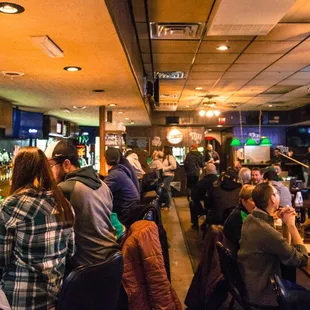 a large group of people sitting at a bar