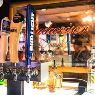 a bar with beer taps and bottles