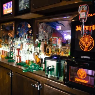 a row of liquor bottles on a bar counter