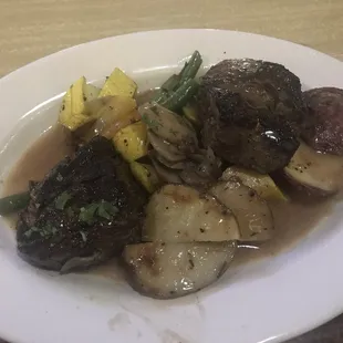 Two Steak medallions  prepared with zucchini, mushrooms, green beans.