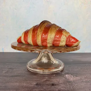 a croissant on a glass plate
