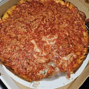 A deep dish pizza that is soggy and watery.  Therevis actually one piece of pizza missing from this pizza.