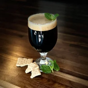 a glass of beer and crackers