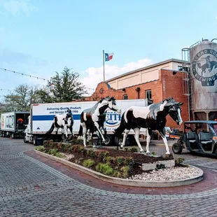 a statue of horses and a truck