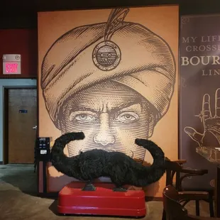 a man in a turban on a stool