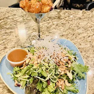 a plate of salad and fried chicken