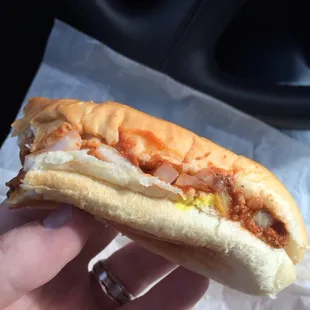 a hand holding a sandwich