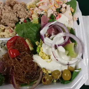 a salad in a styrofoam container