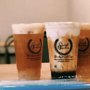 three iced drinks on a table