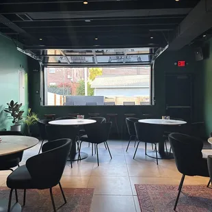 a dining area with tables and chairs