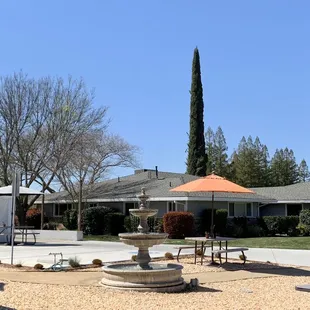 a courtyard with tables and umbrellas