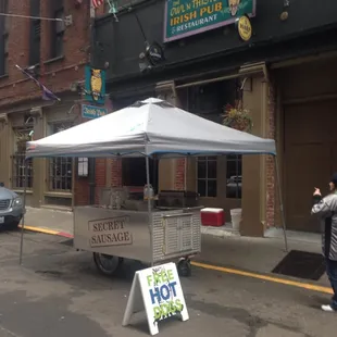 a hot dog cart on a city street