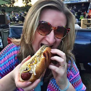 a woman eating a hot dog