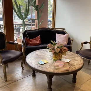 a living room with chairs and a table