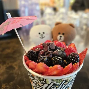 Berry Açai bowl - blackberries, strawberries, blueberries, raspberries, chocolate chips, bee pollen, granola, and honey