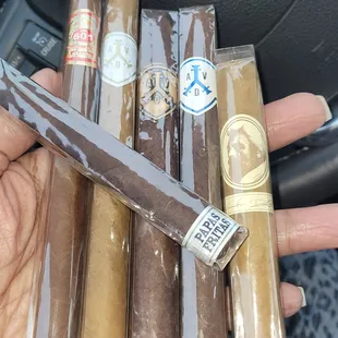 a hand holding cigars