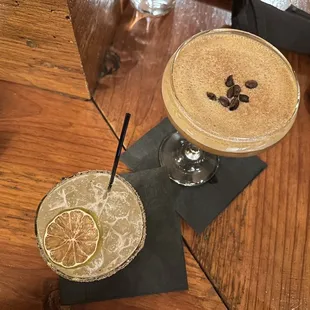 two cocktails on a wooden table