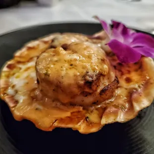 a scallop with a flower on top