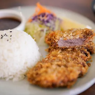 GYUKATSU - Japanese deep-fried top sirloin beef (USDA selected) cutlet over rice in healthy drizzle of tonkatsu sauce and seaweed soup.