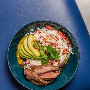 Huevos rancheros with avocado and steak