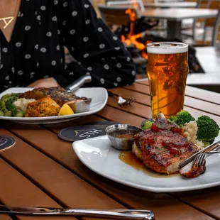 a woman enjoying a meal with a glass of wine