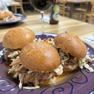 a plate of pulled pork sandwiches
