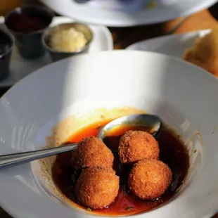 a bowl of deep fried meatballs