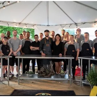 a group of people standing under a tent