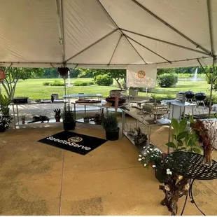 a large tent with tables and chairs