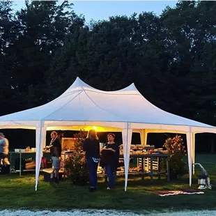 a group of people standing under a tent