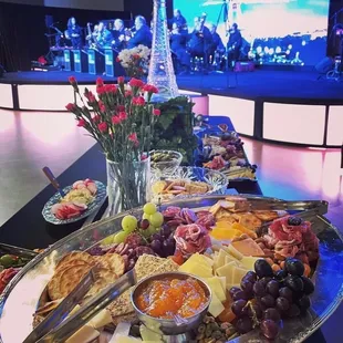 a platter of cheese, crackers, and fruit