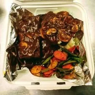 beef and vegetables in a styrofoam container