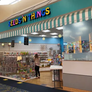  storefront with a woman standing in front of it