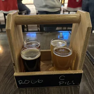 two pints of beer in a wooden crate