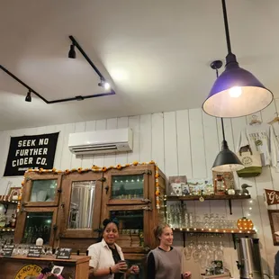 ows two people standing at a bar