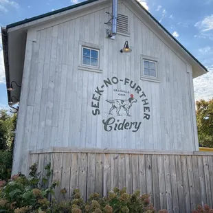 ows a wooden building with a sign on it