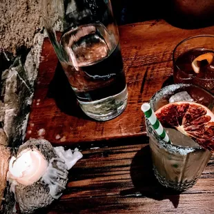 two glasses of alcohol and a grapefruit