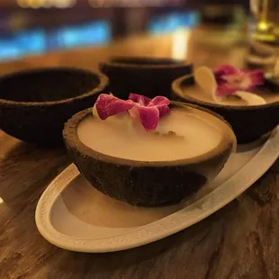 a candle in a coconut bowl