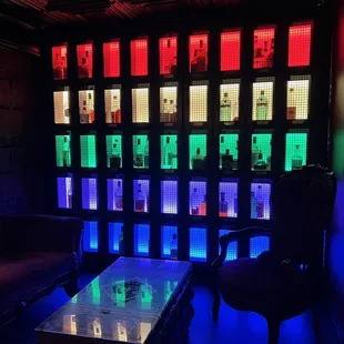 a table and chairs in front of a colorful wall