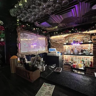 a bar with wine glasses hanging from the ceiling