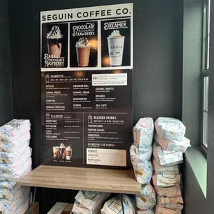 a coffee shop with a menu on the wall