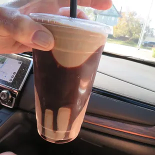 a hand holding a cup of coffee