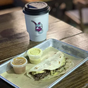 a tray of food and a cup of coffee