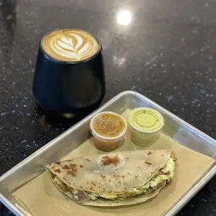 a plate of food and a cup of coffee