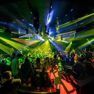 a crowd of people dancing at a nightclub