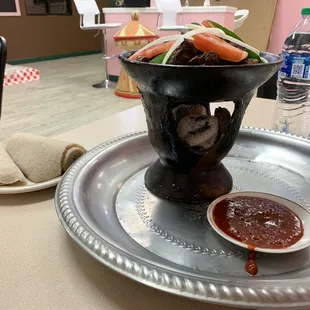 a bowl of food on a silver platter