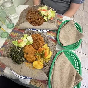 a person sitting at a table with plates of food